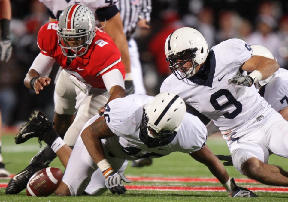 Ohio State quarterback Terrelle Pryor (2), Penn State linebacker Tyrell Sales (46) and safety Mark Rubin (9) chase the fumble during the fourth quarter of an NCAA college football game Saturday, Oct. 25, 2008 in Columbus, Ohio. The ball was recovered by Penn State. (AP Photo/Jay LaPrete)