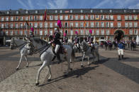 Members of the royal guard wearing face masks to prevent the spread of the coronavirus ride towards the foreign ministry in downtown Madrid, Spain, Wednesday, Sept. 30, 2020. The Spanish capital and its suburbs, the region in Europe where a second coronavirus wave is expanding by far the fastest, are edging closer to stricter mobility curbs and limits on social gatherings after days of a political row that has angered many Spaniards. (AP Photo/Bernat Armangue)