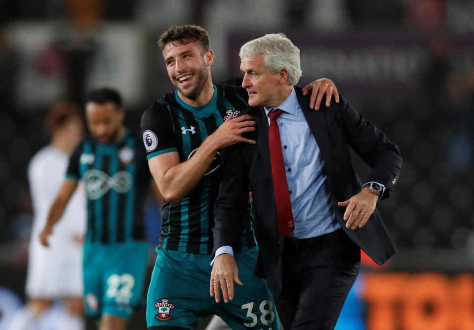 Almost there: Southampton manager Mark Hughes celebrates with Sam McQueen after the match