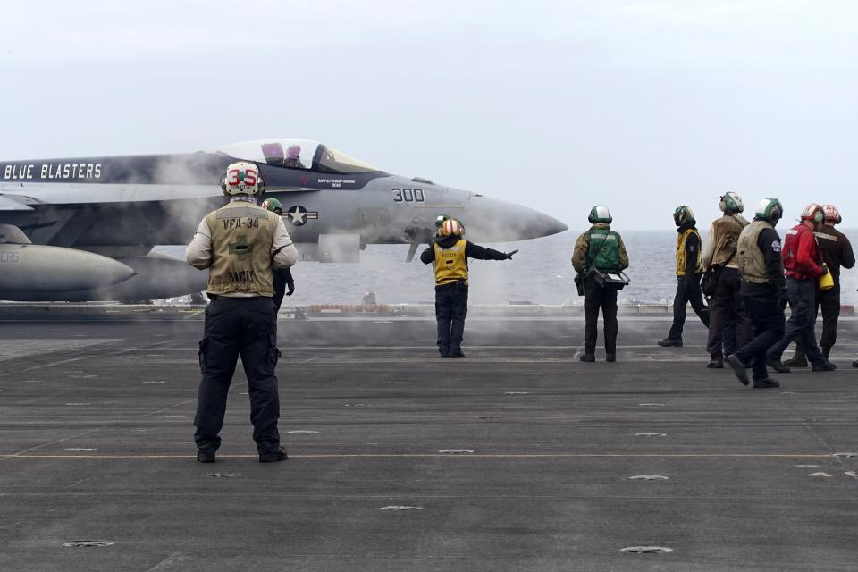 A F-18E fighter jet prepares to take off from USS Theodore Roosevelt aircraft carrier on Thursday, April 11, 2024, during a three-day joint naval exercise by the U.S., Japanese and South Korea at the East China Sea amid tension from China and North Korea. (AP Photo/Mari Yamaguchi)
