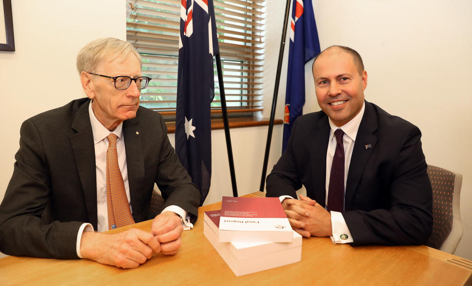 Commissioner Kenneth Hayne and Treasurer Josh Frydenberg (right) are seen with the final report from the Royal Commission into Misconduct in the Banking, Superannuation and Financial Services Industry, at Parliament House in Canberra, Friday, February 1, 2019. (AAP Image/Fairfax Media Pool, Kym Smith)