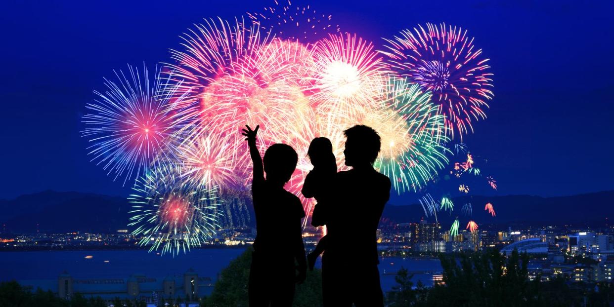 silhouette of family watching firework display