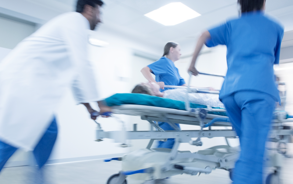 doctors pushing a patient on a gurney