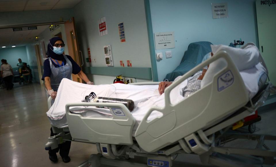 A UK hospital worker with a patient (AP)