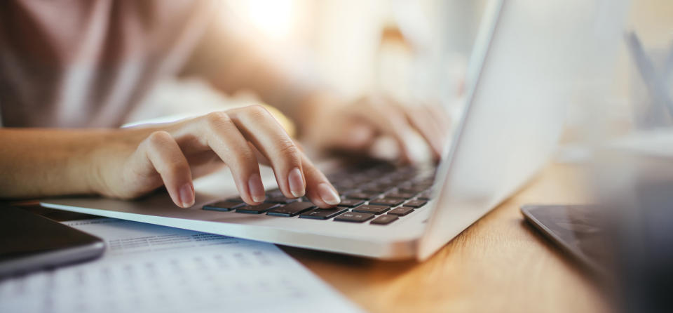 A woman types on the computer