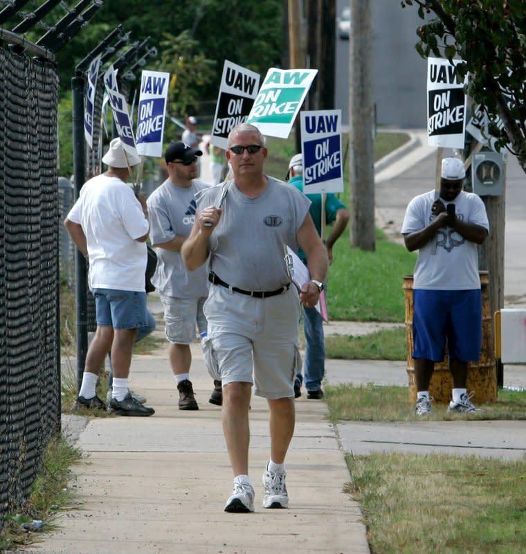 Striking members of United Auto Workers Local 95 picket at the General Motors assembly plant on September 24, 2007, in Janesville, Wis. On September 26, 2007, ending a walkout that lasted less than two days, the United Auto Workers union and General Motors reached a deal in which GM agreed to create a $38.5 billion trust to administer health benefits for retirees. File Photo by Brian Kersey/UPI