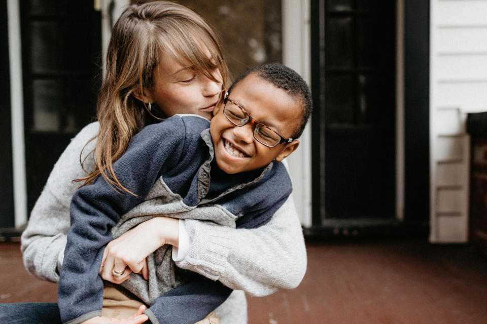 A mom and her son are hugging each other