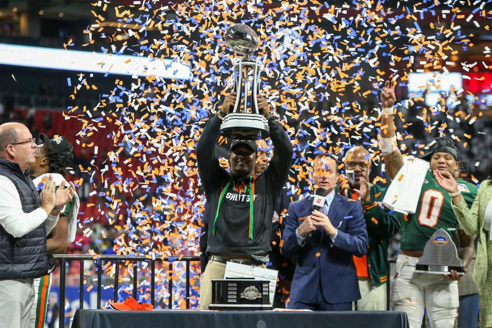 Dec 16, 2023; Atlanta, GA, USA; Florida A&M Rattlers head coach Willie Simmons holds up the Celebration Bowl trophy after a victory against the Howard Bison at Mercedes-Benz Stadium. Mandatory Credit: Brett Davis-USA TODAY Sports