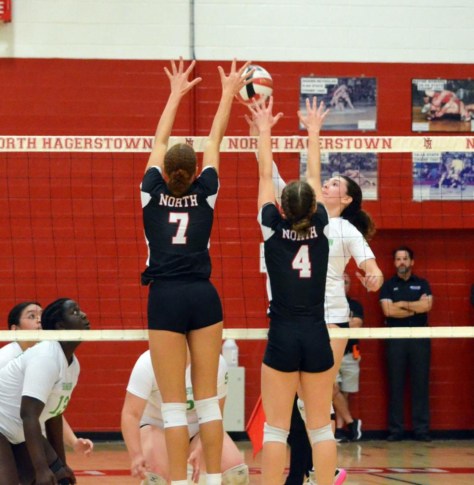 North Hagerstown's Kayla Turner (7) and Aubrey Chamberlin (4) defend at the net during the Hubs' sweep of South Hagerstown on Nov. 7, 2022.