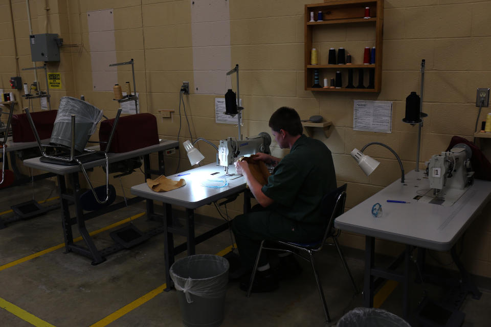 An inmate sews uniforms at a New York state prison in Brocton, N.Y.