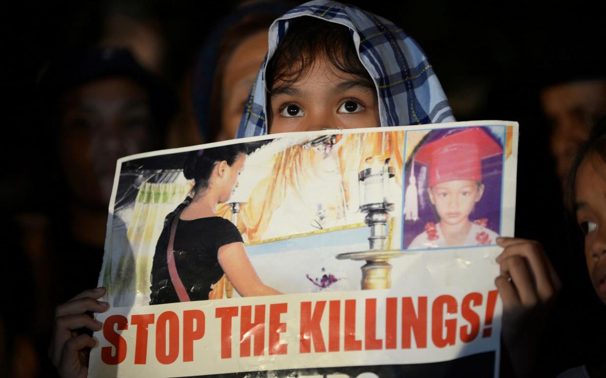 A Filipino child protests President Rodrigo Duterte's war on drugs - AFP