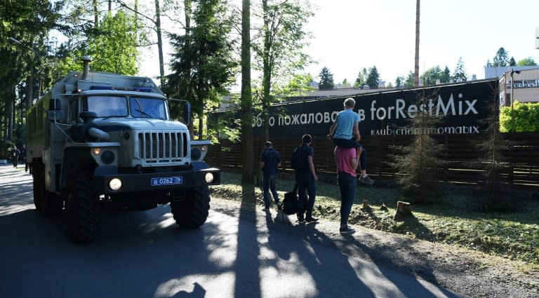 A boy tries to see over the fence of the England team's hotel in Repino outside Saint Petersburg