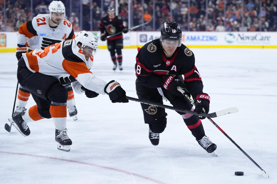 Ottawa Senators' Tim Stutzle, right, tries to get past Philadelphia Flyers' Sean Walker during the third period of an NHL hockey game, Saturday, March 2, 2024, in Philadelphia. (AP Photo/Matt Slocum)