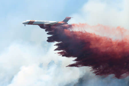 A plane drops fire-retardant chemicals on the 416 Fire near Durango, Colorado, U.S. in this June 9, 2018 handout photo. La Plata County/Handout via REUTERS