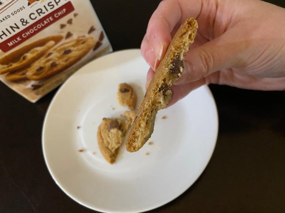 hand holding piece of pepperidge farms chocolate chip cookie