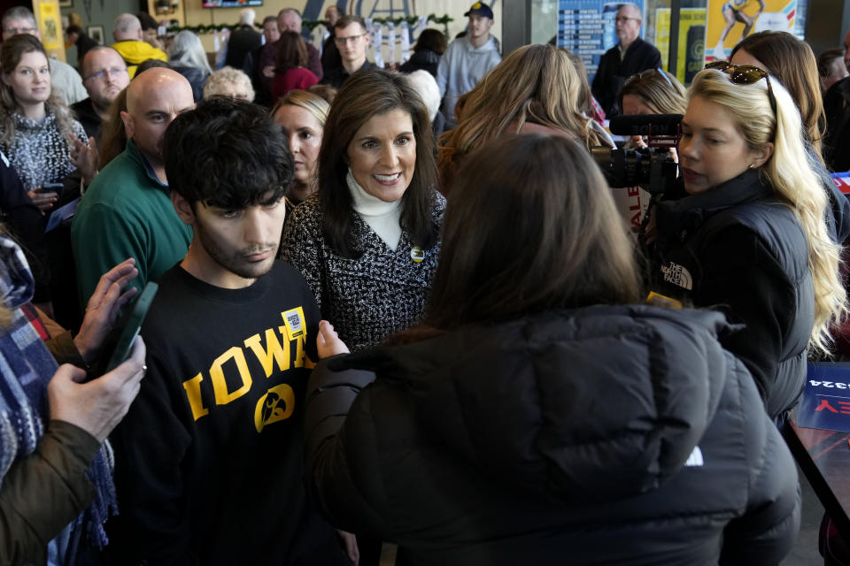 Republican presidential candidate Nikki Haley greets audience members during a campaign stop, Saturday, Dec. 30, 2023, in Coralville, Iowa. (AP Photo/Charlie Neibergall)