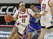 North Carolina State's Jakia Brown-Turner (11) drives around Pittsburgh's Jayla Everett (20) during the first half of an NCAA college basketball game, Thursday, Feb. 25, 2021 in Raleigh, N.C. (Ethan Hyman/The News & Observer via AP, Pool)