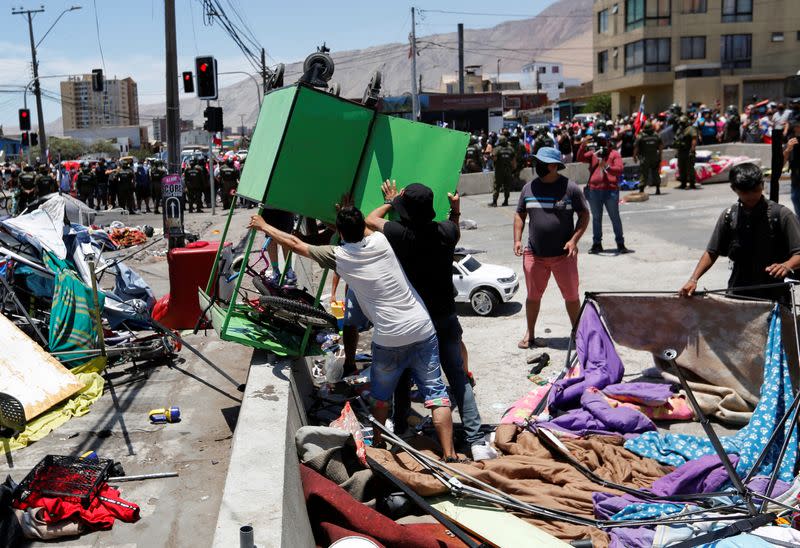 Chileans take part in a rally against migrants and delinquency in Iquique
