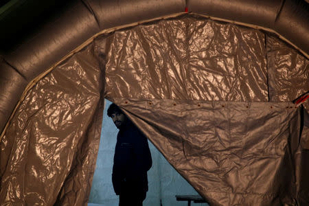 FILE PHOTO: A migrant, part of a group of 69 migrants rescued 117 nautical miles south west of Malta by the Armed Forces of Malta (AFM), waits to be processed after arriving at the AFM Maritime Squadron base in Valletta's Marsamxett Harbour, Malta December 30, 2018. REUTERS/Darrin Zammit Lupi/File Photo