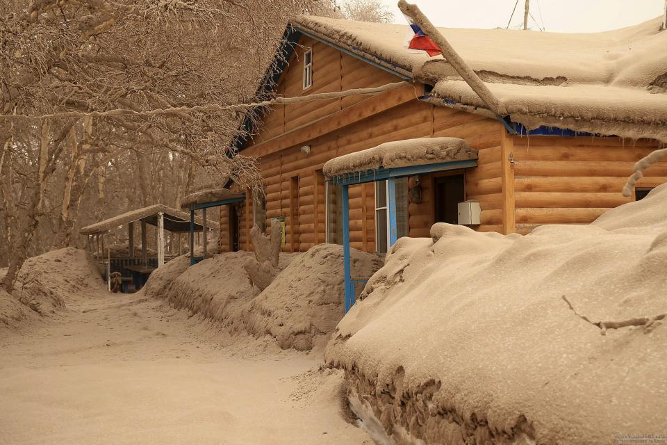 In this photo provided by the Russian Academy of Sciences' Volcanology Institute, volcanic ash covers the ground and houses after the Shiveluch volcano's eruption in Klyuchi village on the Kamchatka Peninsula in Russia, Tuesday, April 11, 2023. The volcano has erupted on Russia's far eastern Kamchatka Peninsula. The eruption early Tuesday of Shiveluch, one of Kamchatka's most active volcanoes, spewed clouds of dust 12 miles into the sky. (Yury Demyanchuk/Russian Academy of Sciences' Volcanology Institute via AP)