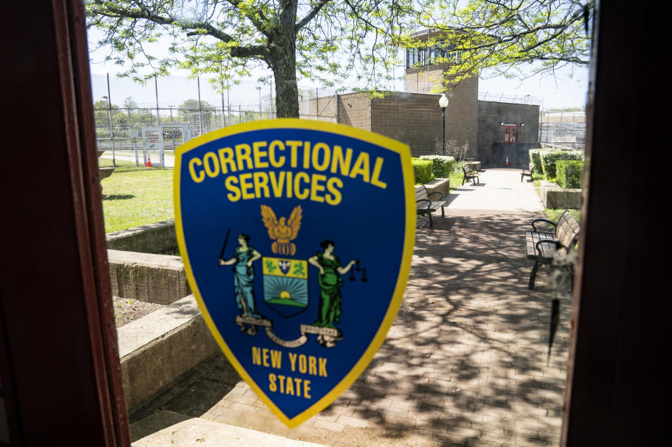 The main guard tower stands in the distance through the door windows of a soundstage at the former Arthur Kill Correctional Facility, Tuesday, May 11, 2021, in the Staten Island borough of New York. The facility was purchased by Broadway Stages in 2017 and has been transformed into a film and television studio. Much of the prison was preserved as a set, lending authenticity to scenes in productions. Five other sound stages are being built on the 69-acre site, giving production companies the ability to shoot entire projects. (AP Photo/John Minchillo)