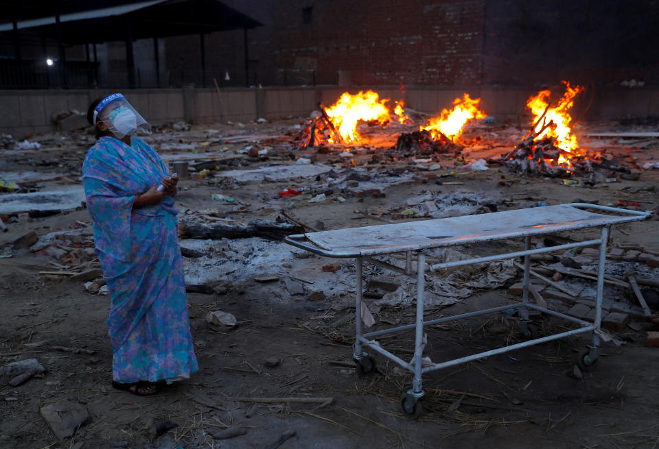 A woman cries during the cremation of her husband, who died from the coronavirus disease (COVID-19), at a crematorium in New Delhi, India May 5, 2021. REUTERS/Adnan Abidi     TPX IMAGES OF THE DAY