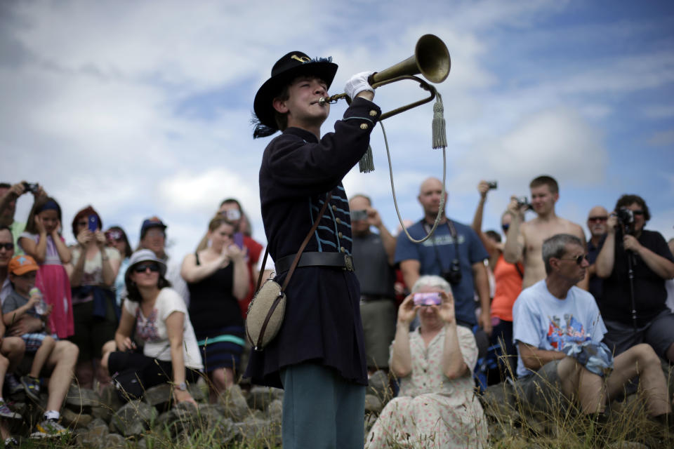 Alan Tolbert, 15, of Shippensburg Pa., plays Taps at Gettysburg National Military Park at the end of a commemorative march where Pickett's Charge took place during ongoing activities commemorating the 150th anniversary of the Battle of Gettysburg, Wednesday, July 3, 2013, in Gettysburg, Pa. Union forces turned away a Confederate advance in the pivotal battle of the Civil War fought July 1-3, 1863, which was also the war’s bloodiest conflict with more than 51,000 casualties. (AP Photo/Matt Rourke)