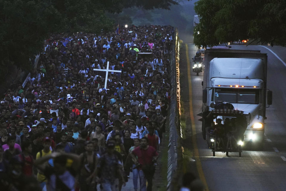 Migrants, many from Central American and Venezuela, walk along the Huehuetan highway in Chiapas state, Mexico, early Tuesday, June 7, 2022. The group left Tapachula on Monday, tired of waiting to normalize their status in a region with little work and still far from their ultimate goal of reaching the United States. (AP Photo/Marco Ugarte)