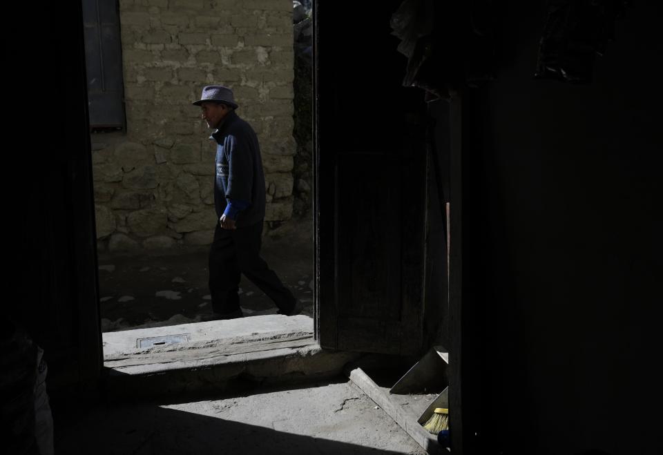 A man walks past a restaurant in Tupe, Peru, Tuesday, July 19, 2022. As Peru´s President Pedro Castillo marks the first anniversary of his presidency, his popularity has been decimated by his chaotic management style and corruption allegations, but in rural areas like Tupe, voters believe the fault for the executive crisis lies not only with Castillo, but with Congress, which has sought to remove him twice. (AP Photo/Martin Mejia)