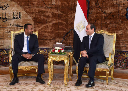 Egyptian President Abdel Fattah al-Sisi (R) meets with Ethiopian Prime Minister Abiy Ahmed at the Ittihadiya presidential palace in Cairo, Egypt, June 10, 2018. in this handout picture courtesy of the Egyptian Presidency. The Egyptian Presidency/Handout via REUTERS