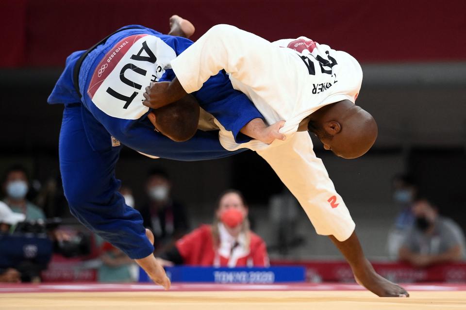 <p>France's Teddy Riner (white) and Austria's Stephan Hegyi compete in the judo men's +100kg elimination round bout during the Tokyo 2020 Olympic Games at the Nippon Budokan in Tokyo on July 30, 2021. (Photo by Franck FIFE / AFP)</p> 