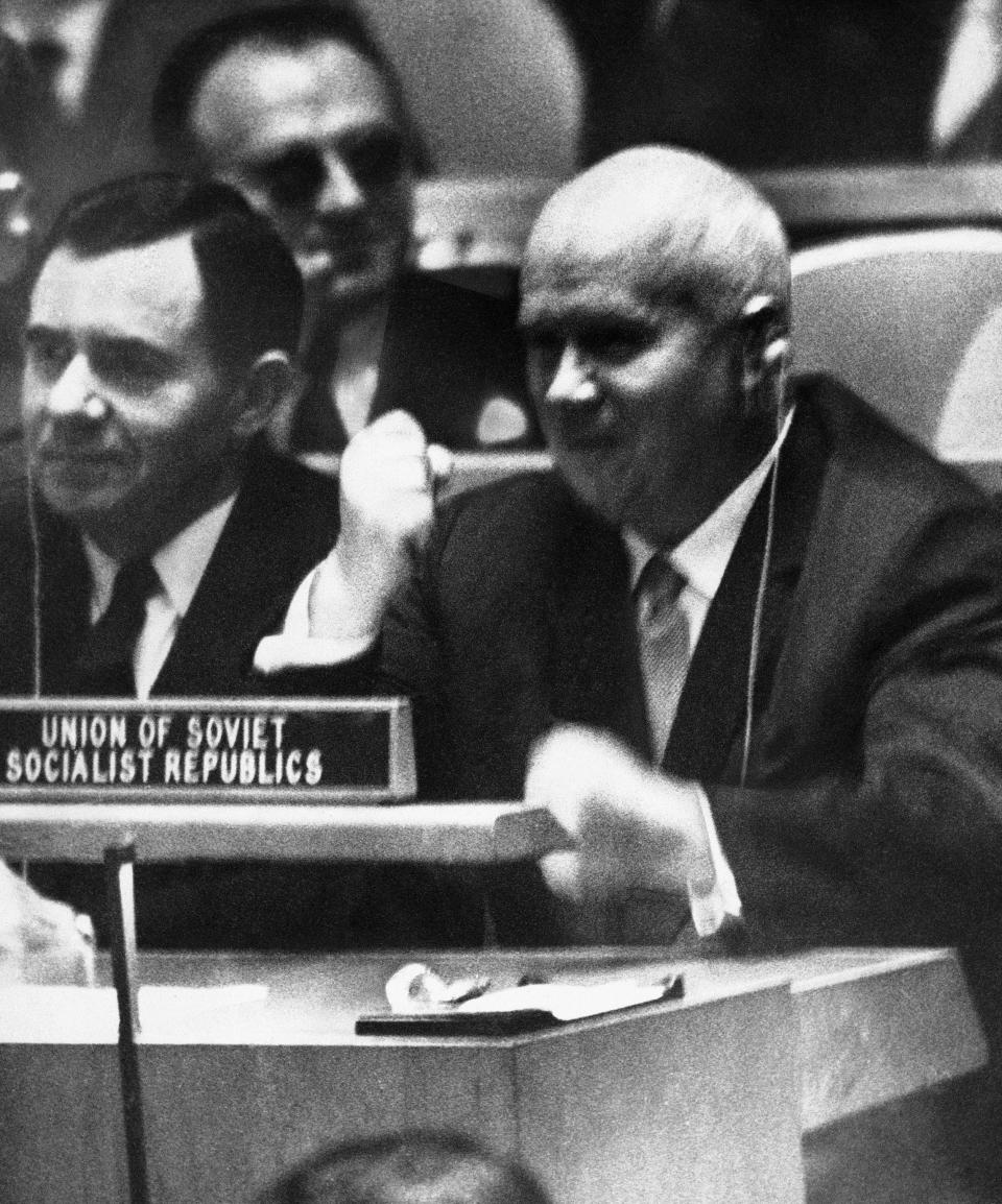 FILE - In this Oct. 12, 1960 file photo, Soviet Premier Nikita Khrushchev pounds his desk at the United Nations with his fist during a General Assembly debate on colonialism at U.N headquarters. The Soviet leader did more than raise a few eyebrows in 1960 as the Cold War raged when he pounded his shoe on a desk in fury after the head of a delegation from the Philippines said Moscow had swallowed up the freedom of the people of Eastern Europe. The Berlin Wall went up the next year. (AP Photo, File)