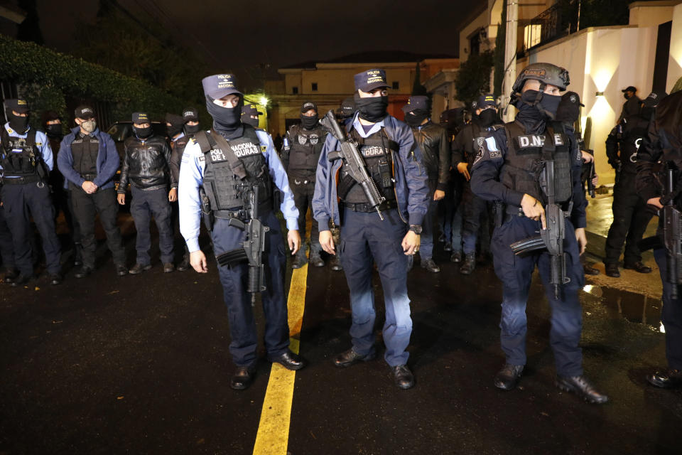 Special Forces Police stand near the house of former Honduran President Juan Orlando Hernandez in Tegucigalpa, Honduras, late Monday, Feb. 14, 2022. After years of speculation in Honduras, the United States formally requested the arrest and extradition of Hernández less than three weeks after he left office. (AP Photo/Elmer Martinez)