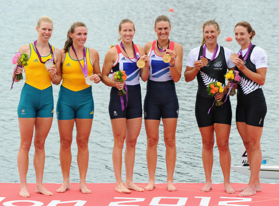 WINDSOR, ENGLAND - AUGUST 01: Gold medallists Helen Glover and Heather Stanning of Great Britain celebrate on the podium with silver medallists Sarah Tait and Kate Hornsey of Australia and bronze medallists Rebecca Scown and Juliette Haigh of New Zealand after competing in the Women's Pair Final A on Day 5 of the London 2012 Olympic Games at Eton Dorney on August 1, 2012 in Windsor, England. (Photo by Mike Hewitt/Getty Images)