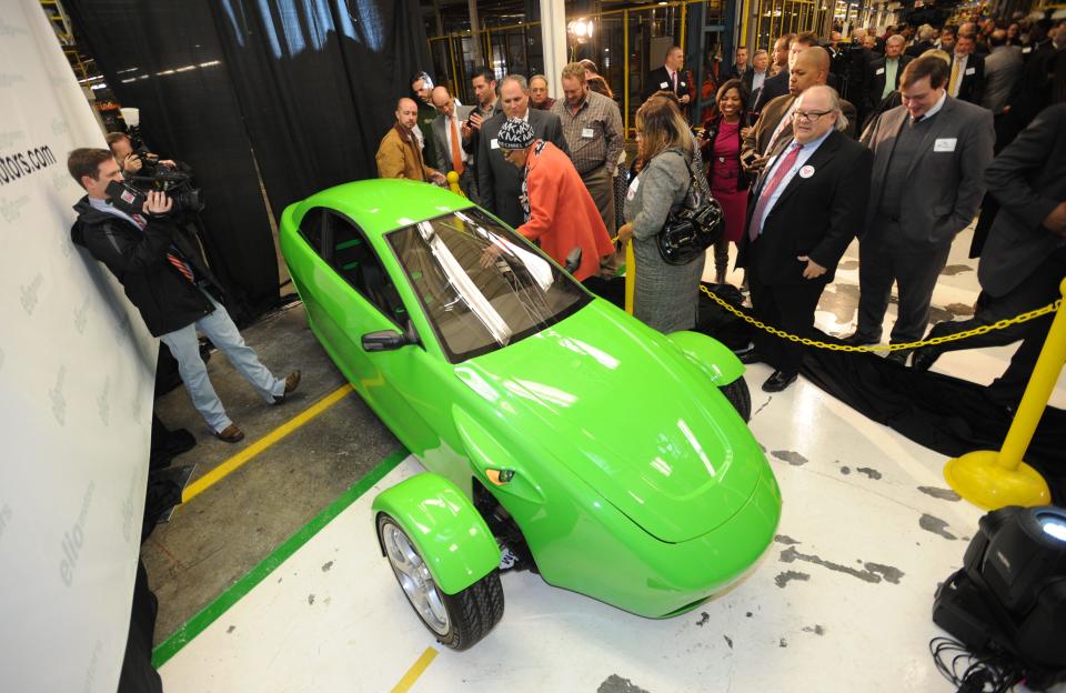 Elio Motors shows off an early version of its prototype 3-wheeled, 84 mpg, two-seat vehicle at a press conference in 2013 to promote its deal to take over the former General Motors property in Shreveport, Lousiana, where the company promised to add 1,500 jobs.