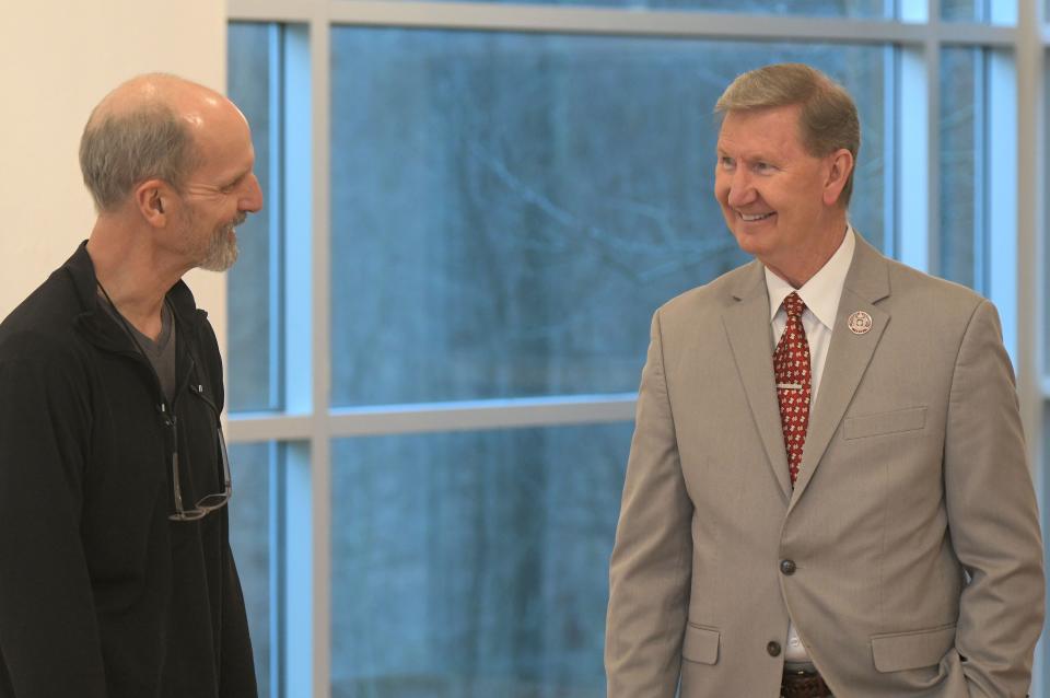OSU President Walter "Ted" Carter Jr. and John Thrasher, professor in the art department at Ohio State University's Mansfield campus, chat Wednesday in the Pearl Conard Art Gallery.
