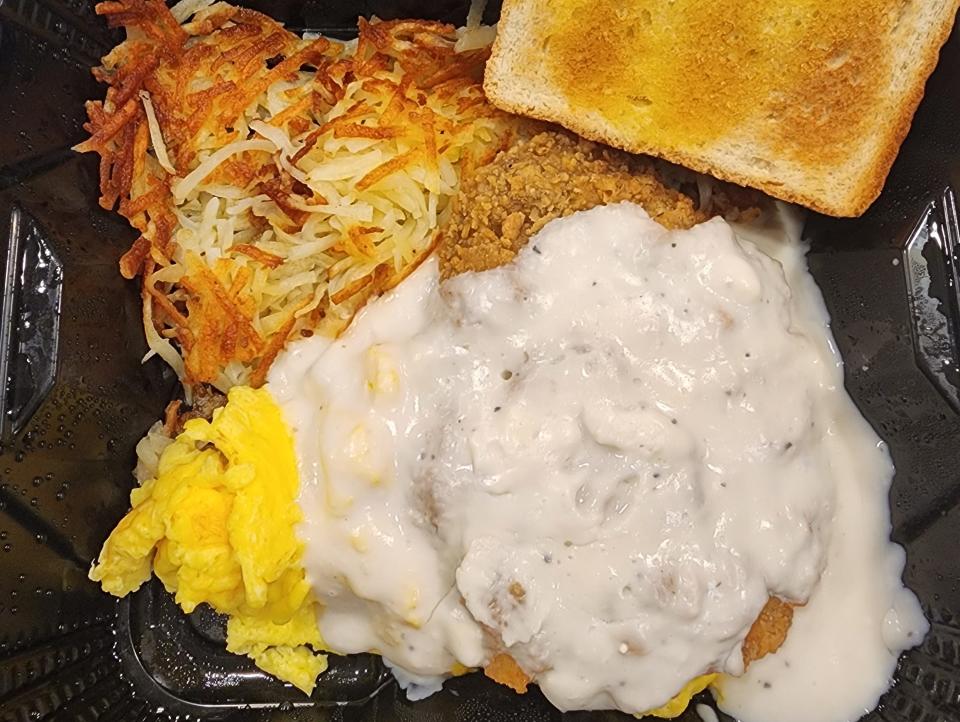 Denny's country-fried steak with a slice of toast and scrambled eggs