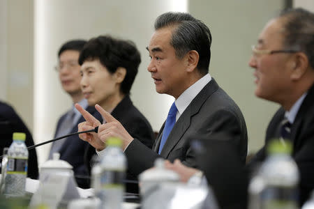 Chinese State Councilor and Foreign Minister Wang Yi (2-R) speaks during a meeting with Myron Brilliant, executive vice president and head of International Affairs at the U.S. Chamber of Commerce (not pictured) at the Ministry of Foreign Affairs in Beijing, China February 19, 2019. Wu Hong/Pool via REUTERS
