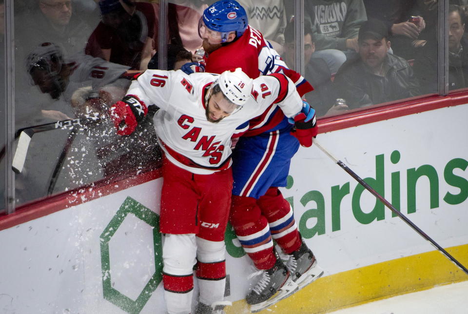 Carolina Hurricanes' Vincent Trocheck, left, and Montreal Canadiens defenseman Jeff Petry (26) crash into the boards while vying for the puck during the second period of an NHL hockey game Saturday, Feb. 29, 2020, in Montreal. (Peter McCabe/The Canadian Press via AP)