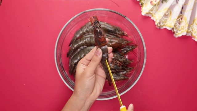 Slitting back of prawn with small knife