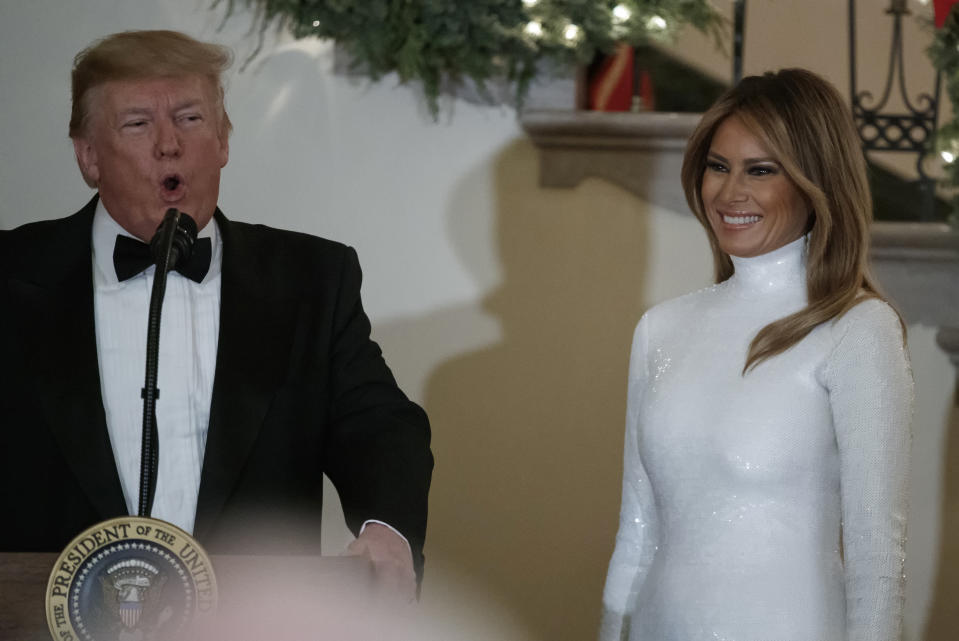 President Donald Trump, joined by first lady Melania Trump, speaks during the Congressional Ball in the Grand Foyer of the White House in Washington, Saturday, Dec. 15, 2018. (AP Photo/Carolyn Kaster)