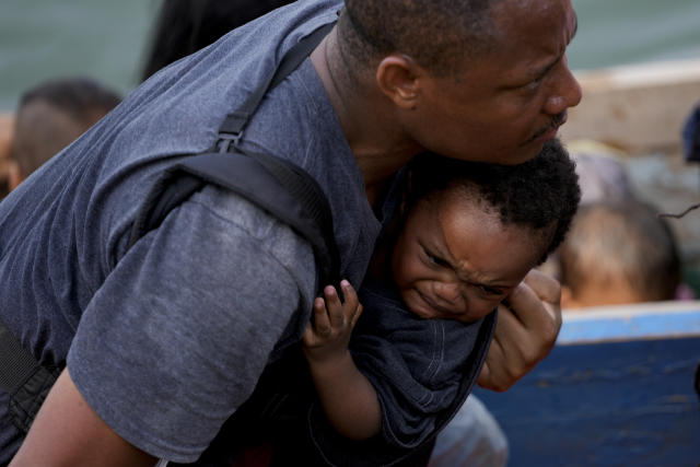 A migrant disembarks from a boat upon his arrival in Bajo Chiquito, Panama, after walking across the Darien Gap from Colombia, Saturday, May 6, 2023. (AP Photo/Natacha Pisarenko)