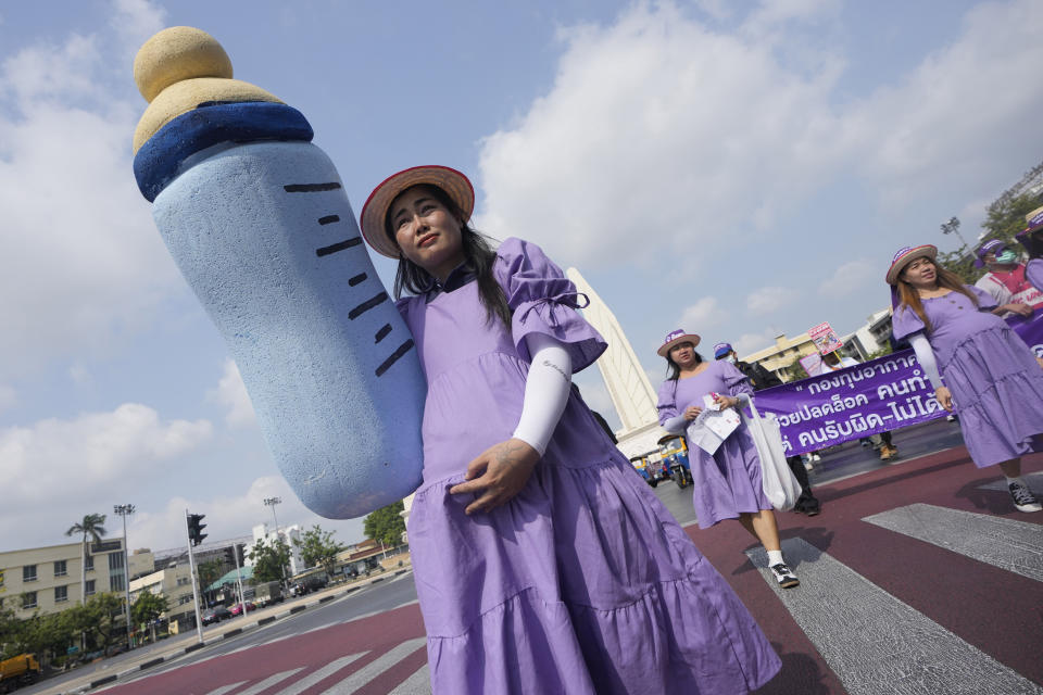 Thai workers dresses as pregnant women demand a paid maternity leave for up to 180 days during an International Women's Day rally in Bangkok, Thailand, Friday, March 8, 2024. (AP Photo/Sakchai Lalit)