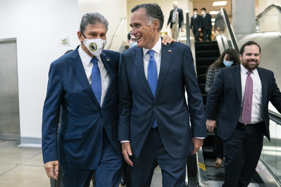 Sen. Joe Manchin, D-WVa., left and Sen. Mitt Romney, R-Utah, walk together on Capitol Hill in Washington, Thursday, Nov. 4, 2021. (AP Photo/Carolyn Kaster)