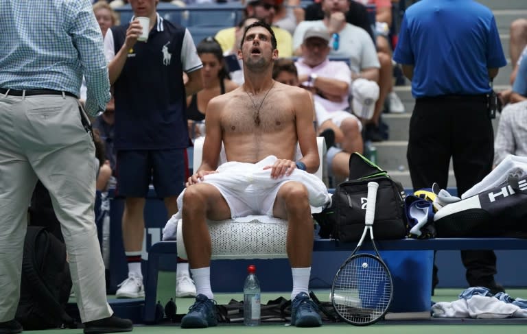 Naked truth: Novak Djokovic takes a break from the heat -- without his shirt -- while playing against Marton Fucsovics