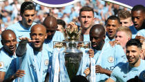 Manchester City's Vincent Kompany (second left), Yaya Toure (second right) and Sergio Aguero prepare to lift the Premier League trophy after the Premier League match at the Etihad Stadium, Manchester.