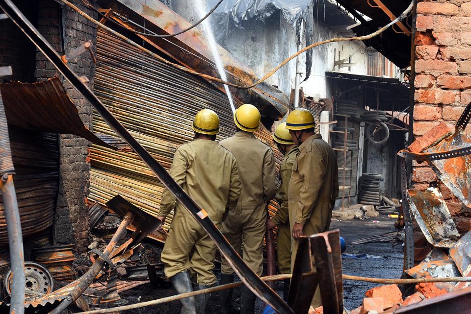 Firemen try to douse a fire after the shops were set ablaze by miscreants over the new citizenship law, at Tyre Market, Gokalpuri, on February 26, 2020 in New Delhi, India. Adequate security has been deployed in Maujpur, Seelampur, Gokulpuri and other localities of Northeast Delhi which have seen violent protests in the last three days. Stones were pelted at the police, houses burnt and vehicles smashed. Seventeen people, including a Delhi Police head constable, have been killed in the clashes, and more than 250 injured. (Photo by Raj K Raj/Hindustan Times via Getty Images)