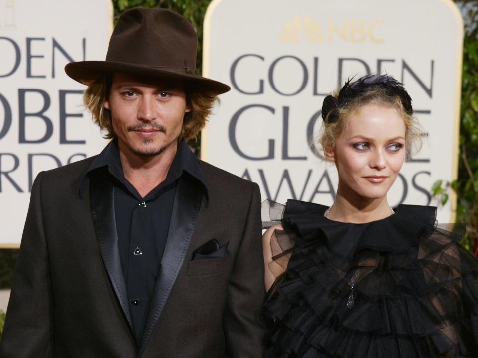 Johnny Depp (L) and Girlfriend Vanessa Paradis attend the 61st Annual Golden Globe Awards at the Beverly Hilton Hotel on January 25, 2004 in Beverly Hills, California