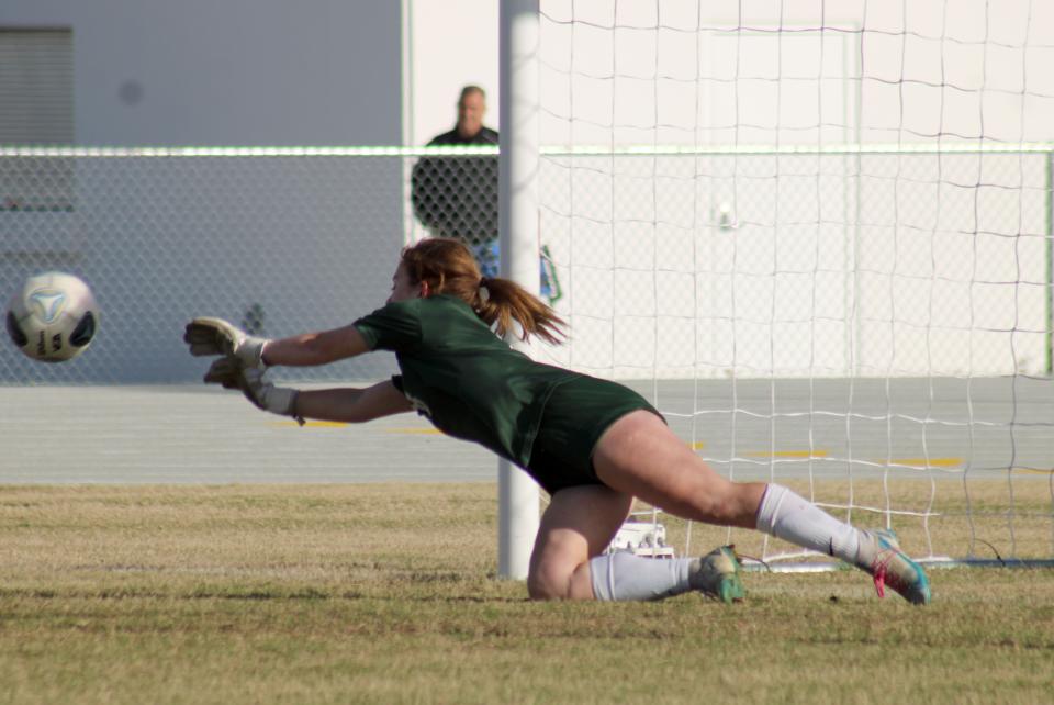 Fleming Island goalkeeper Macy Opp (8) saves a penalty kick during the 2023 playoffs against Ponte Vedra.