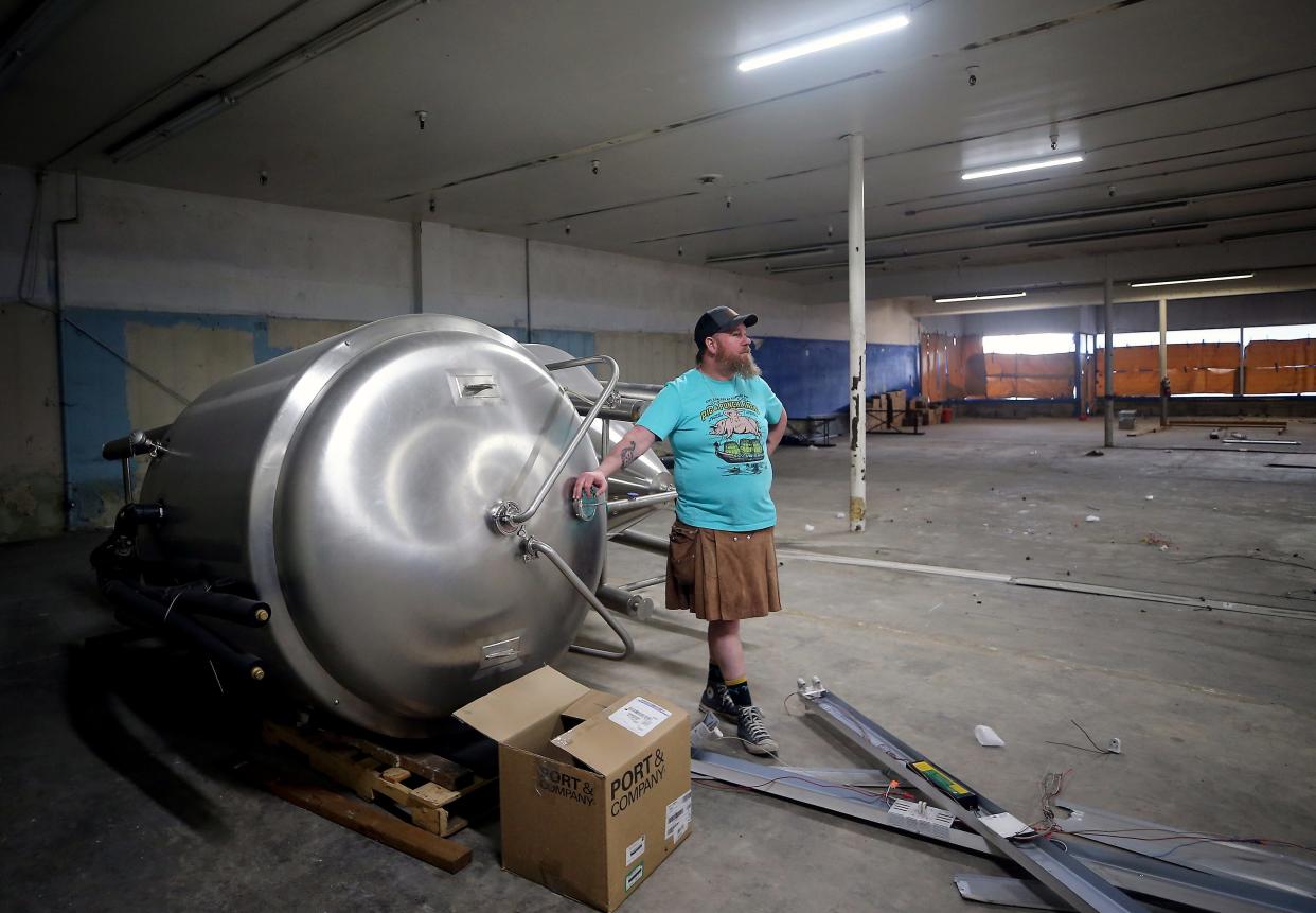 Dave Lambert leans against a brewing tank wile talking about the demolition and renovations that are under way at what will be his new Slippery Pig location at 645 Callow Avenue in Bremerton, on Tuesday, Jan. 30, 2024.